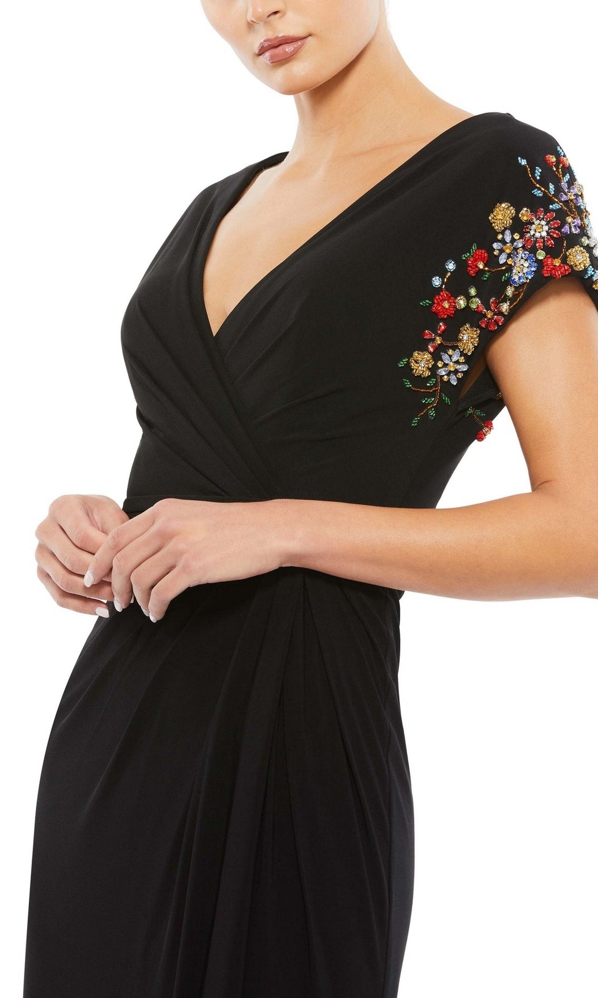 Woman wears a black cap-sleeve Mac Duggal 55709 long formal gown with a V-neckline and colorful floral embroidery on the sleeves; shown from shoulders to mid-thigh.